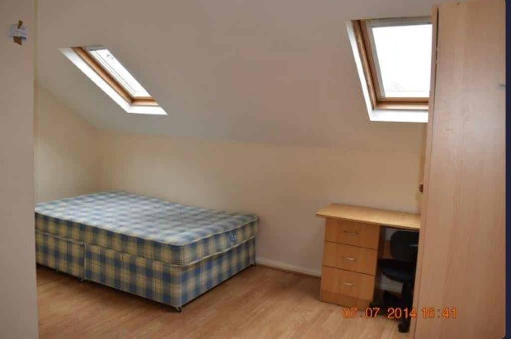 A cozy double bedroom with ample natural light ...