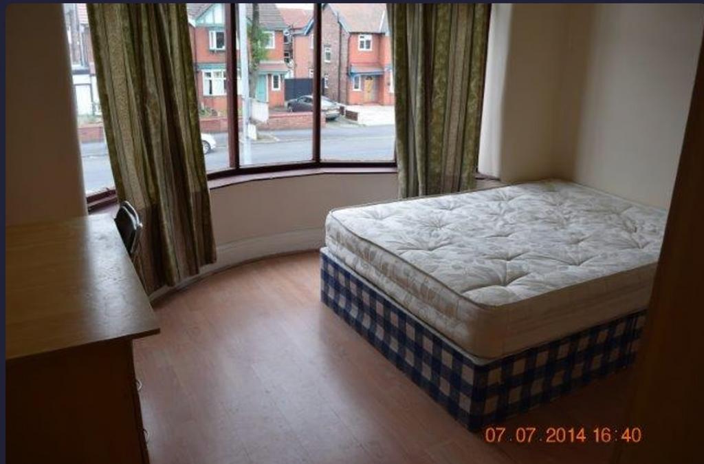 A bright and spacious double bedroom featuring ...