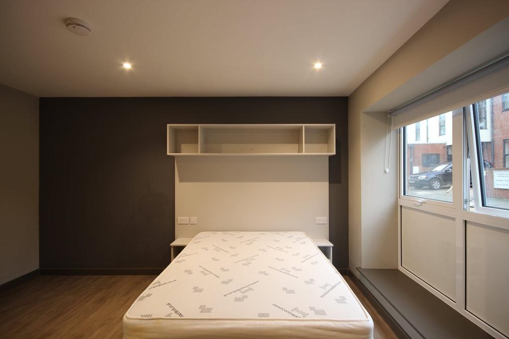 A spacious and bright double bedroom with moder...