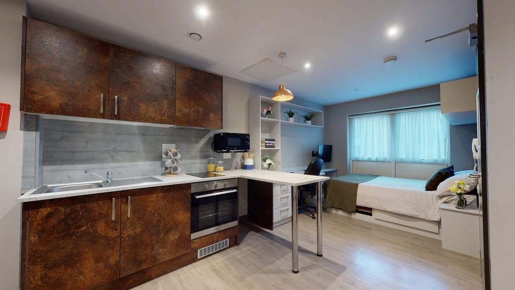 A modern kitchenette and living space, featurin...