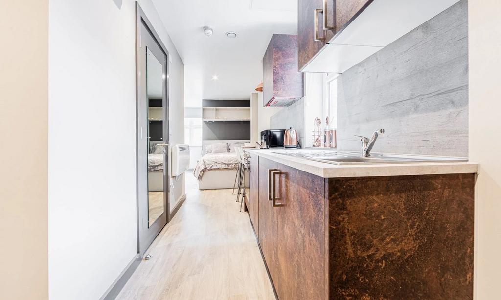 A modern and tidy kitchenette featuring sleek c...