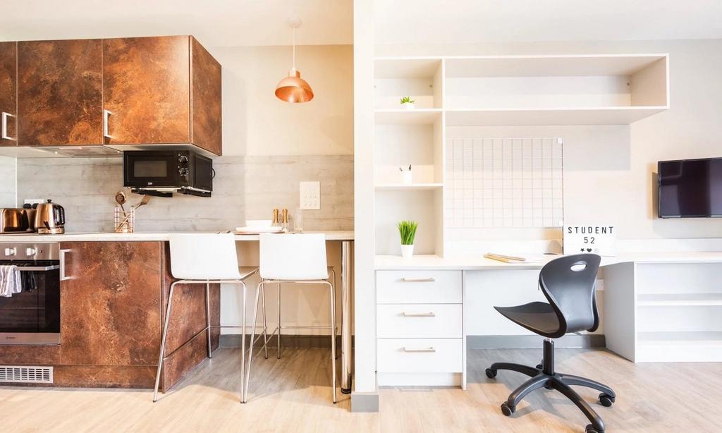 A modern kitchenette featuring sleek cabinetry ...