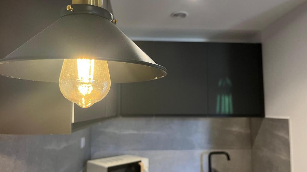 Modern kitchen corner featuring sleek dark cabi...