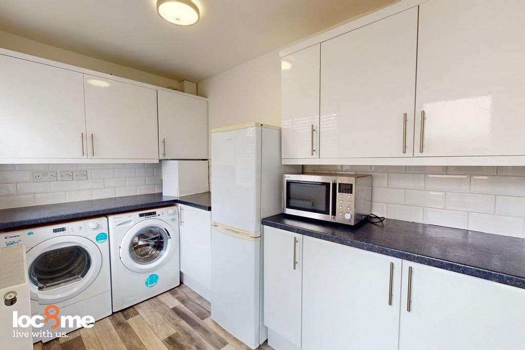A bright and modern kitchenette featuring ample...