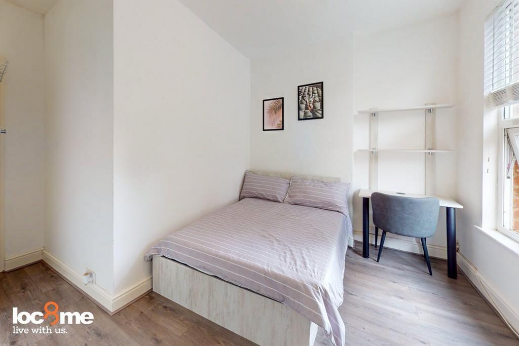 A bright and cozy double bedroom with a comfort...