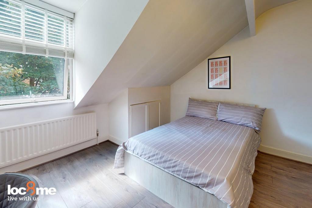 A bright and inviting double bedroom with ample...
