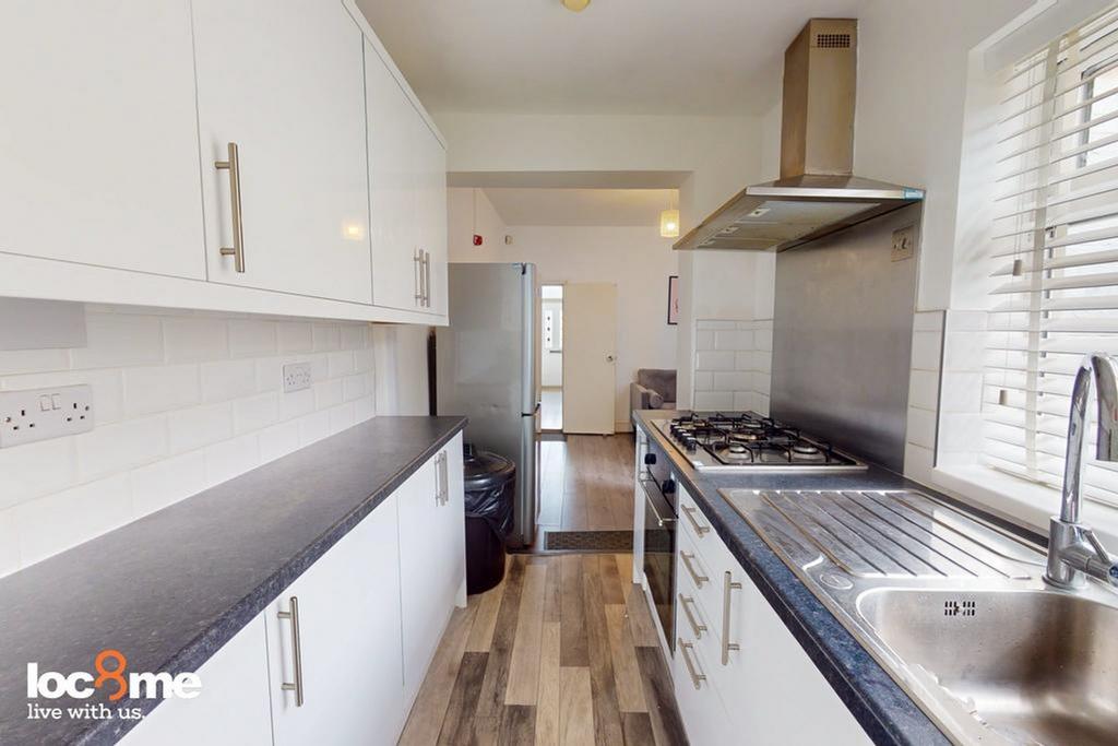 A modern and clean kitchenette with ample stora...