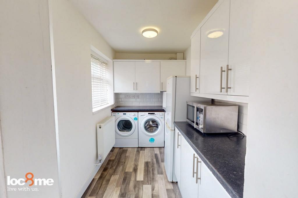 A bright and modern kitchenette featuring essen...