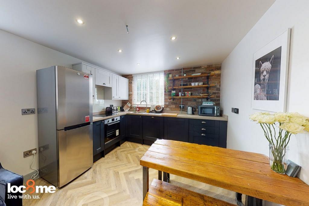 A modern and spacious kitchenette featuring sty...