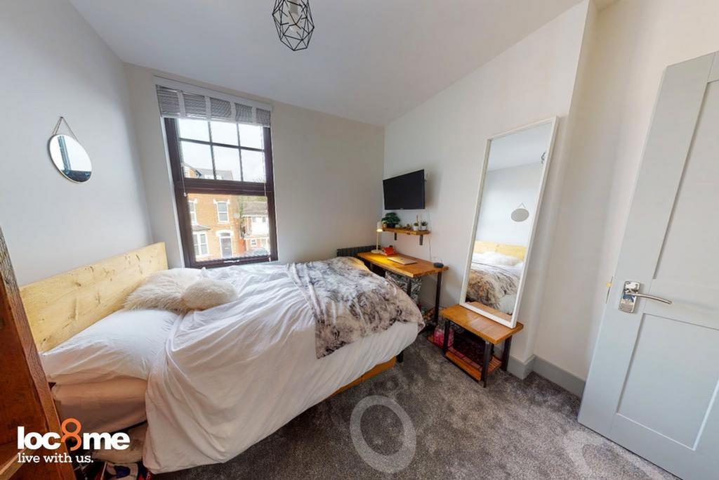 A bright and inviting double bedroom featuring ...