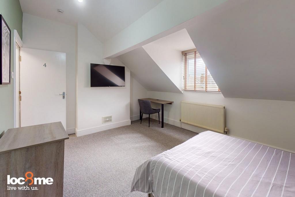 A bright and spacious double bedroom featuring ...