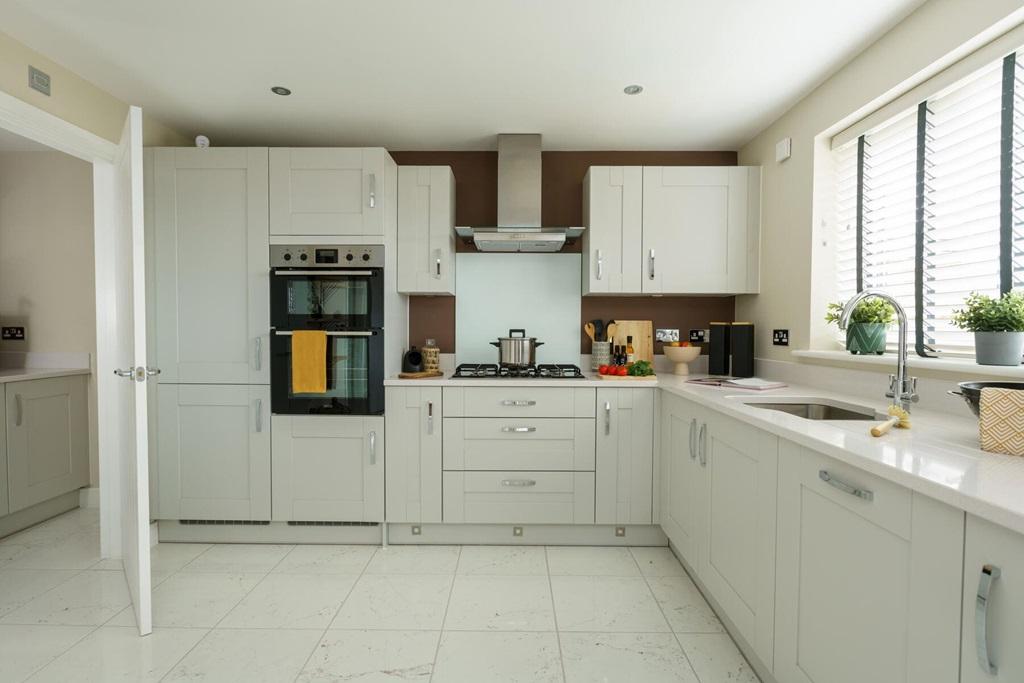 The L-shaped modern kitchen offers ample...