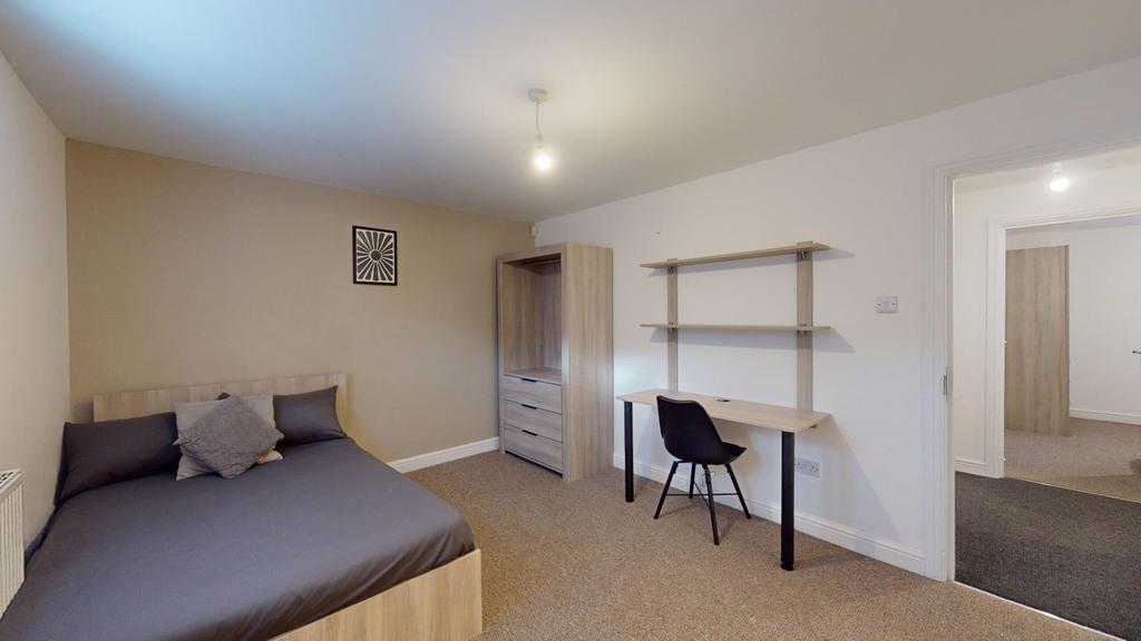 A bright and spacious double bedroom featuring ...