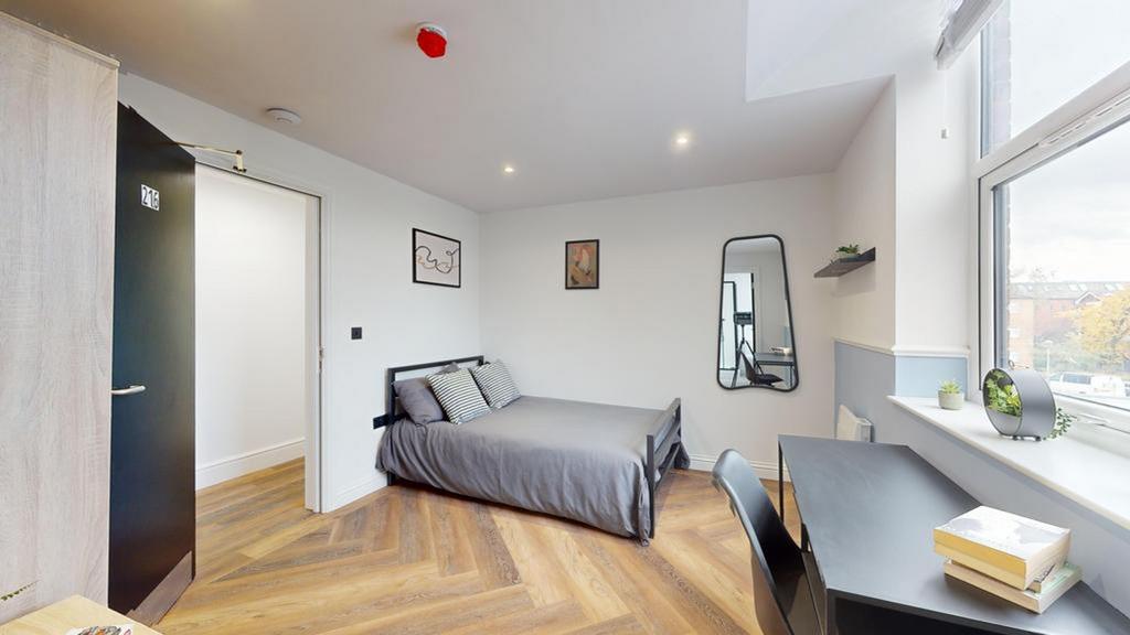 A bright and stylish double bedroom with modern...