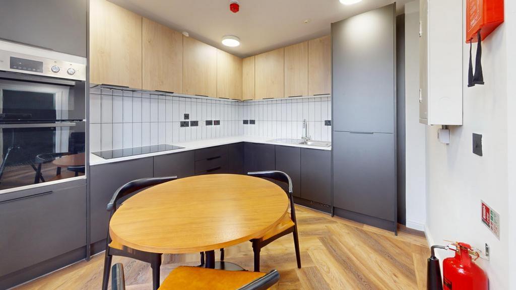 A modern and tidy kitchenette featuring sleek c...