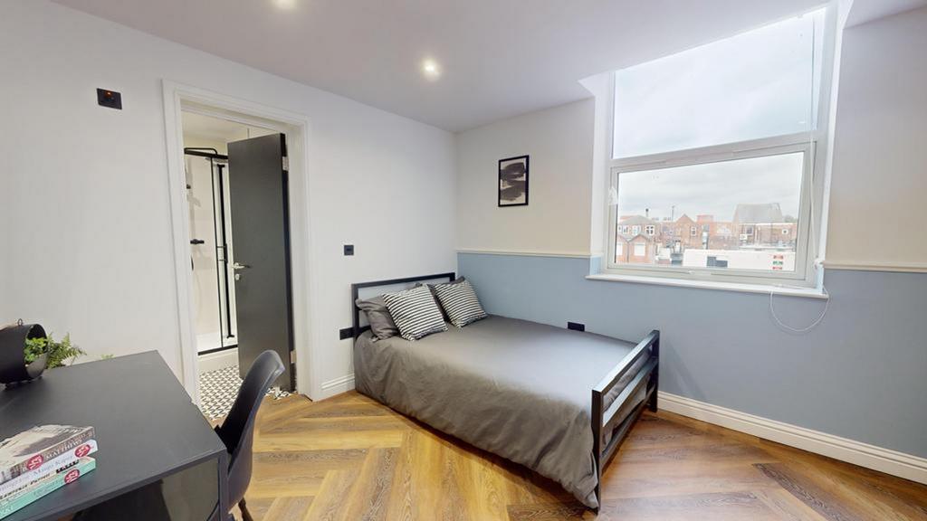 A spacious and stylish double bedroom featuring...