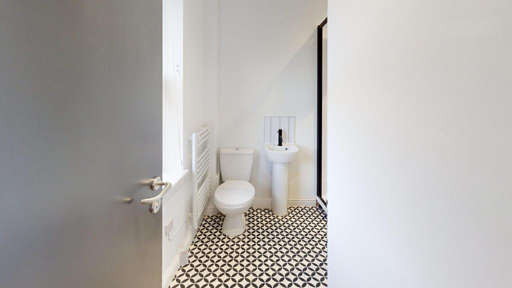 A modern bathroom featuring stylish tiles and a...