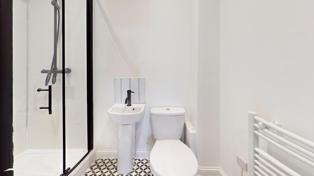 A modern and tidy bathroom featuring a sleek sh...