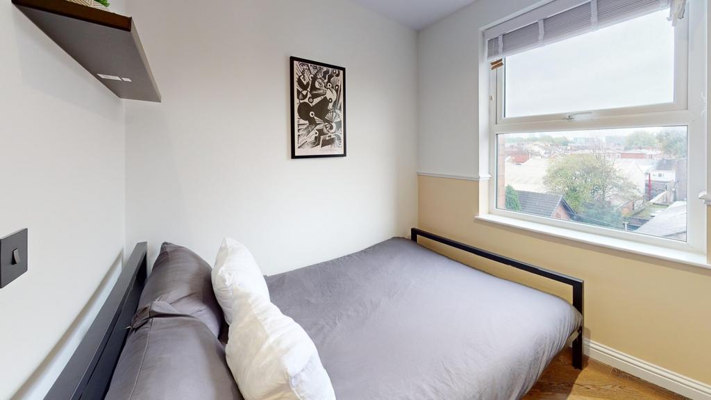 A bright and inviting double bedroom with moder...