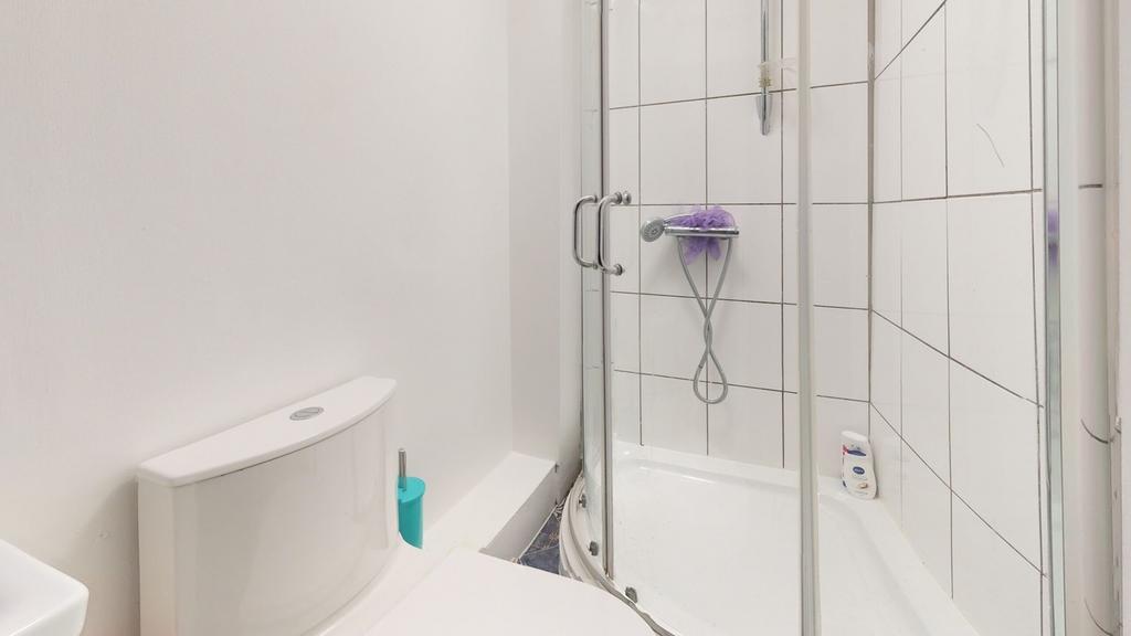 A modern and tidy bathroom featuring a shower, ...