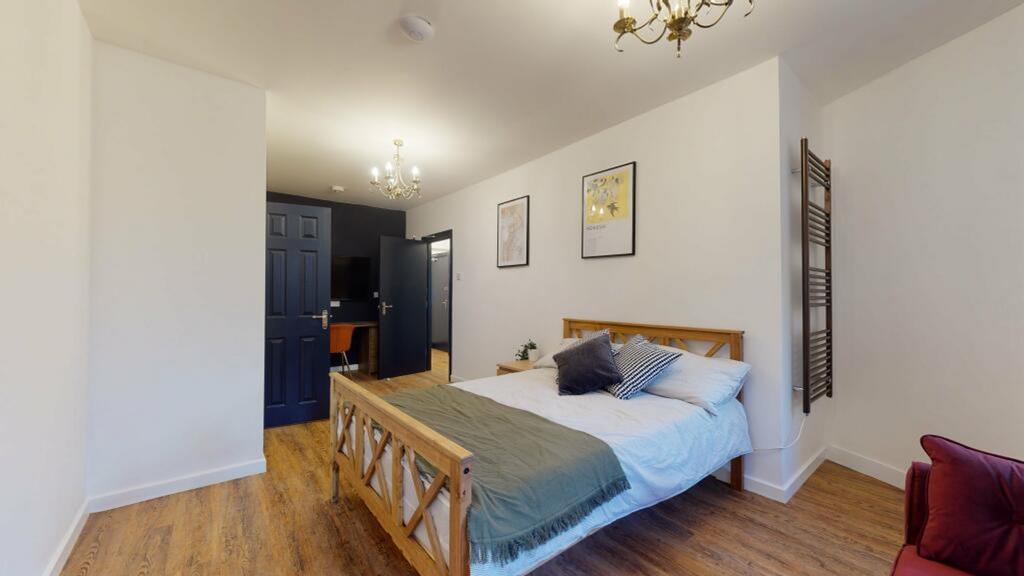 A spacious and inviting double bedroom with mod...