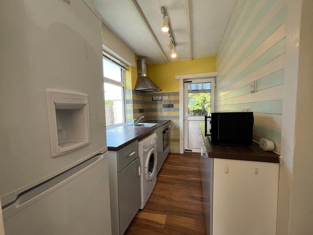 A bright and modern kitchenette featuring ample...