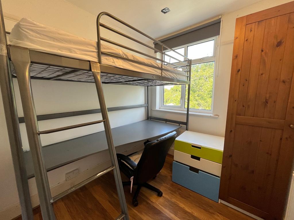 A bright and tidy double bedroom featuring a co...