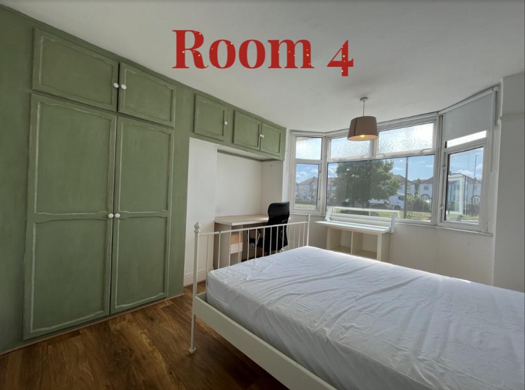 A bright and spacious double bedroom with moder...