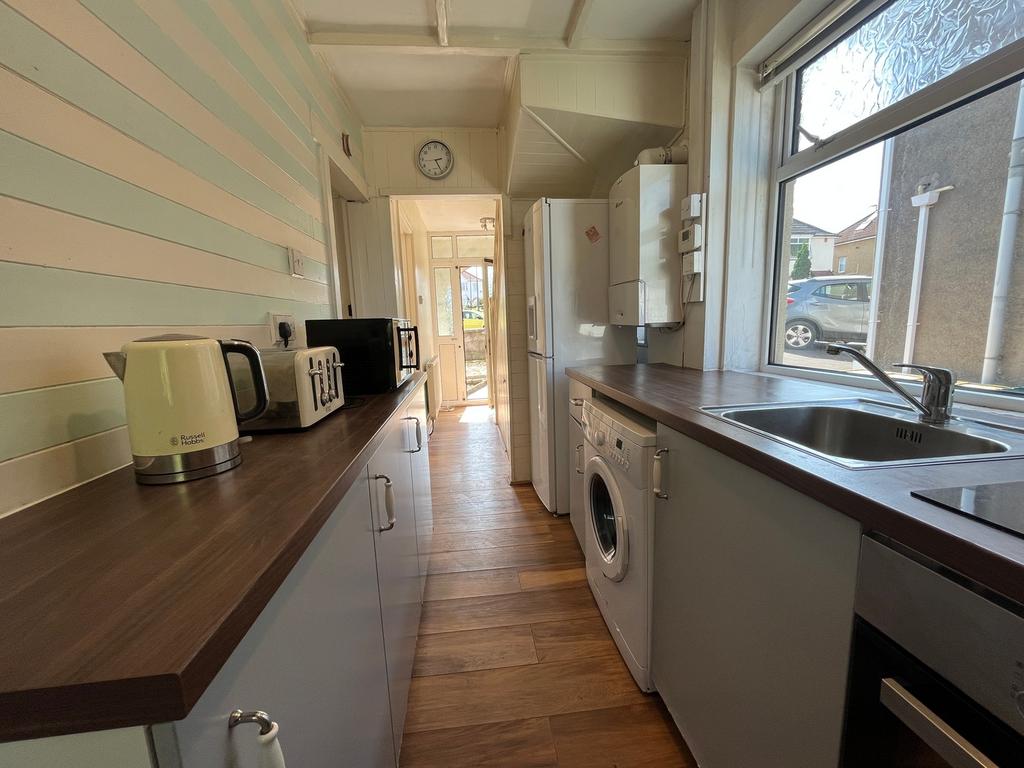 A bright and tidy kitchenette with modern appli...