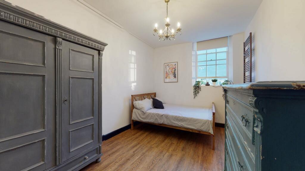 A bright and inviting double bedroom with styli...