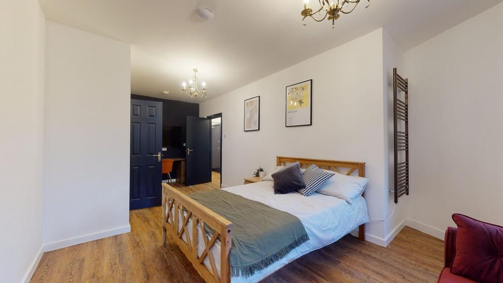 A bright and inviting double bedroom featuring ...