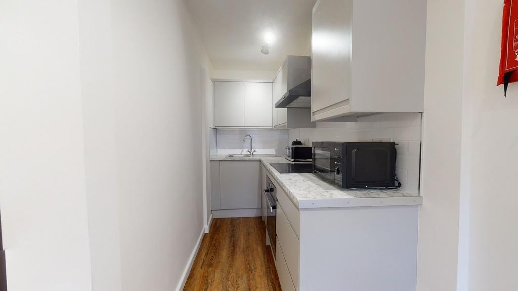 A bright and tidy kitchenette with modern appli...