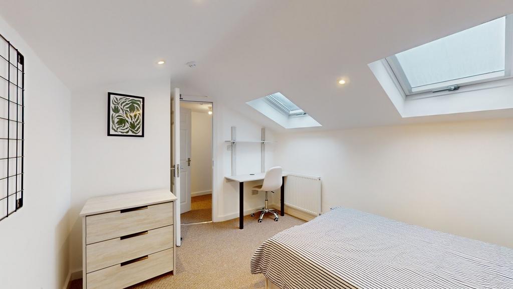 A bright and spacious double bedroom featuring ...