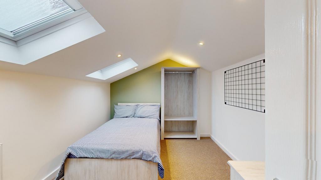 A bright and tidy single bedroom featuring a co...