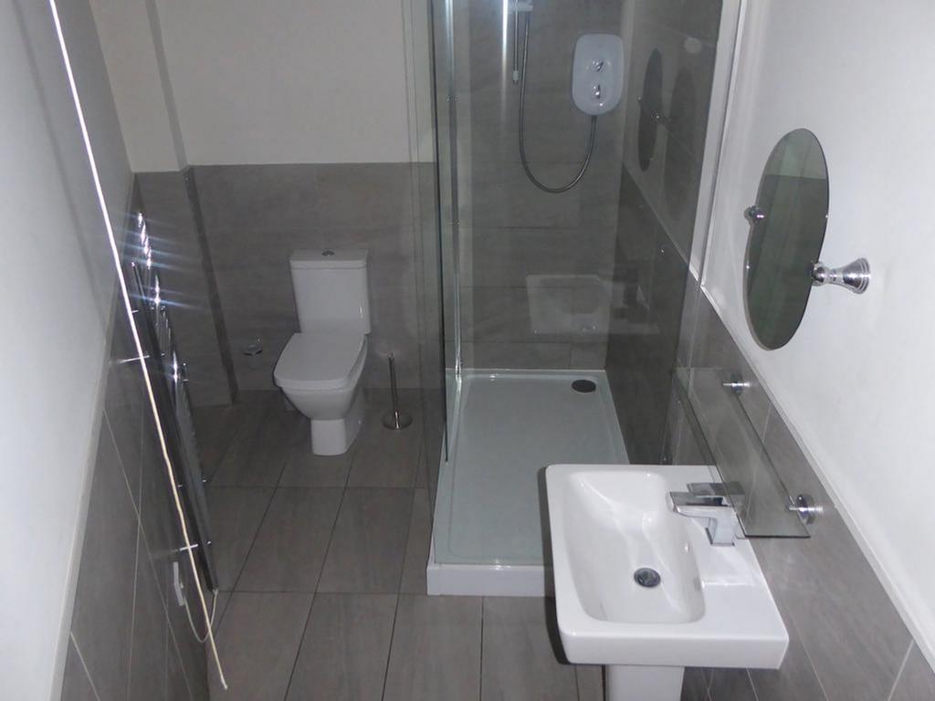 A modern and clean bathroom featuring a shower,...