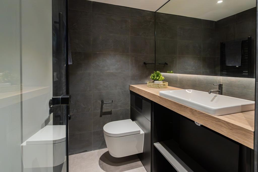 A modern and stylish large bathroom featuring s...