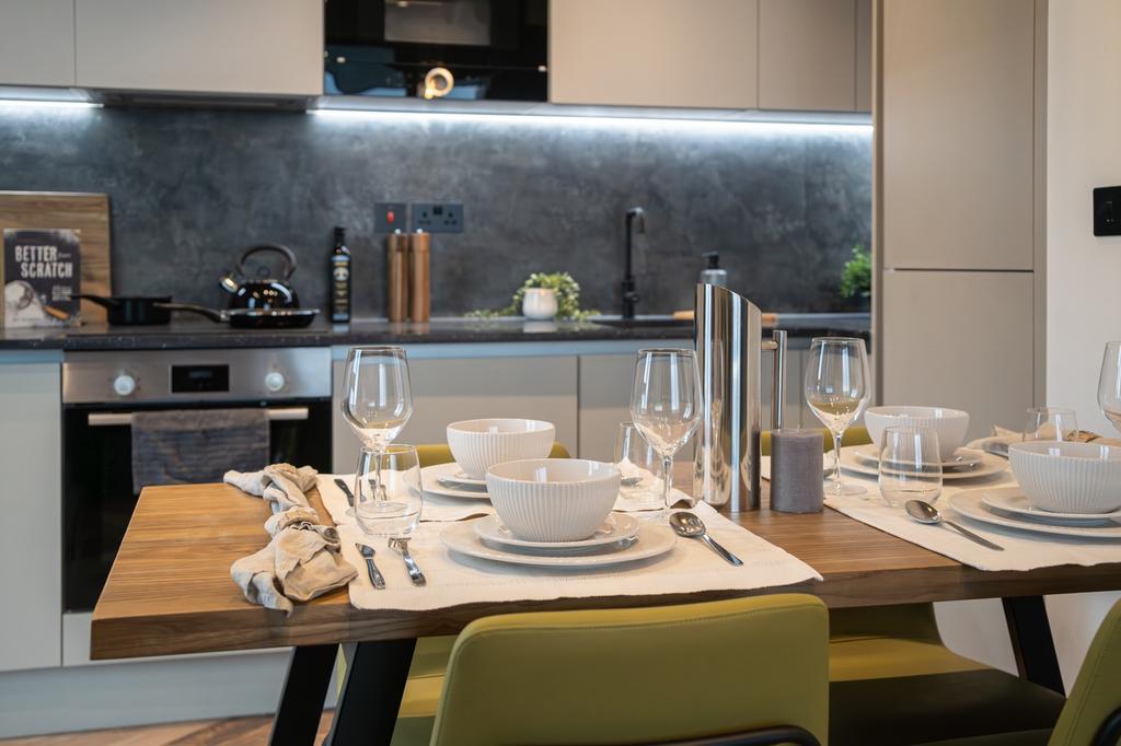 A modern and stylish kitchenette with a dining ...