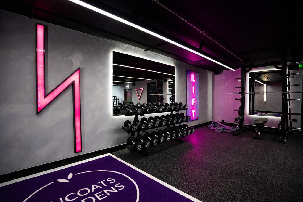 A modern and vibrant gym featuring a variety of...