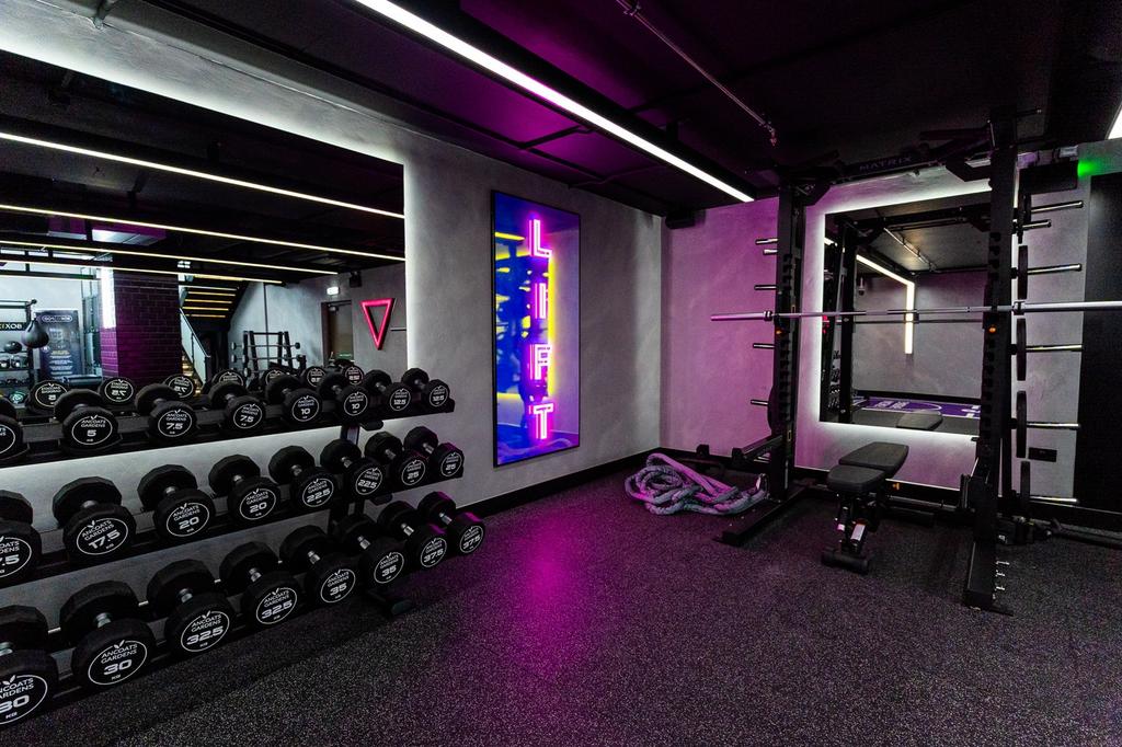 A modern and well equipped gym featuring a vari...