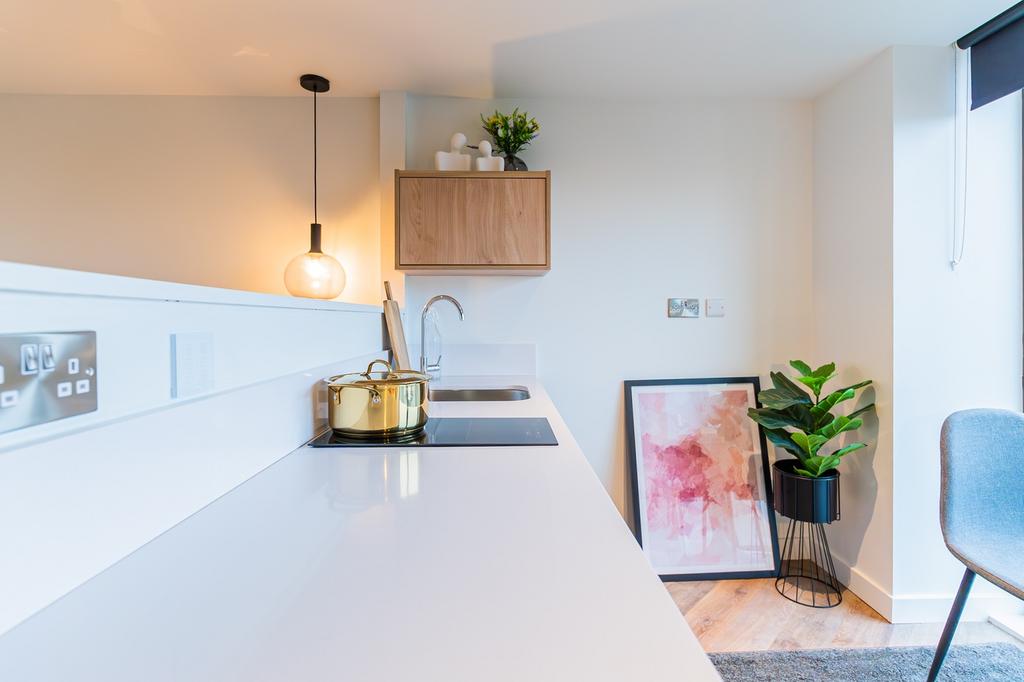 A bright and modern kitchenette with stylish de...