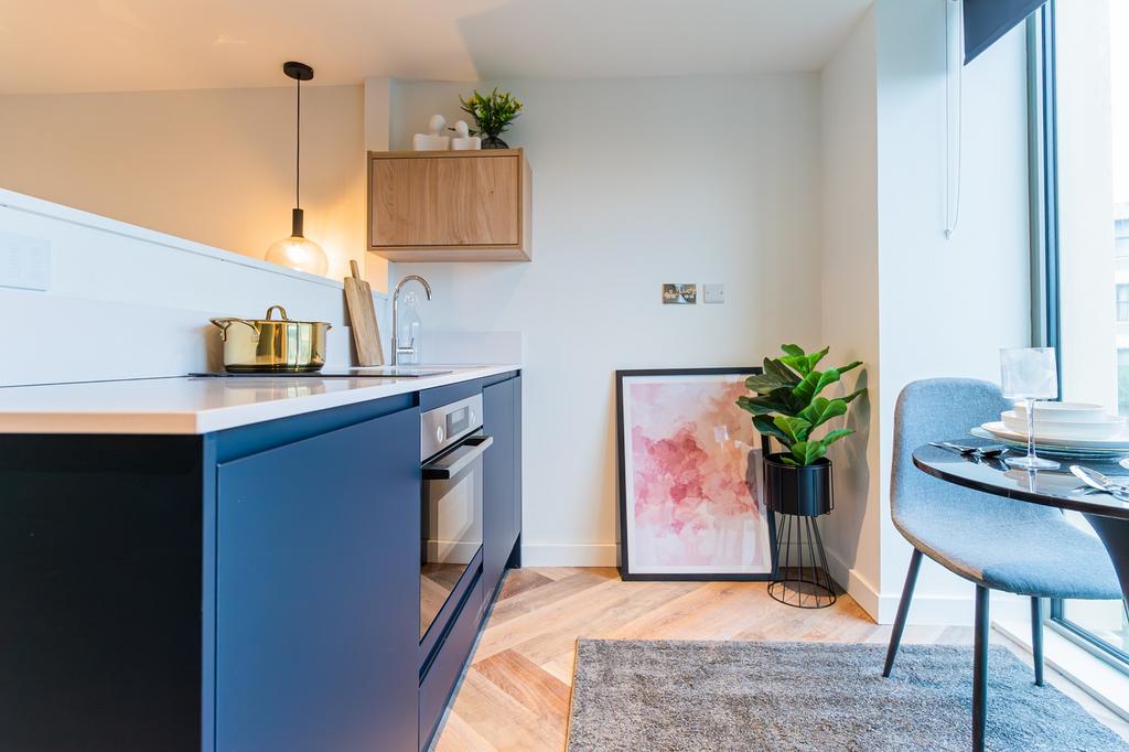 A modern kitchenette with stylish decor and amp...