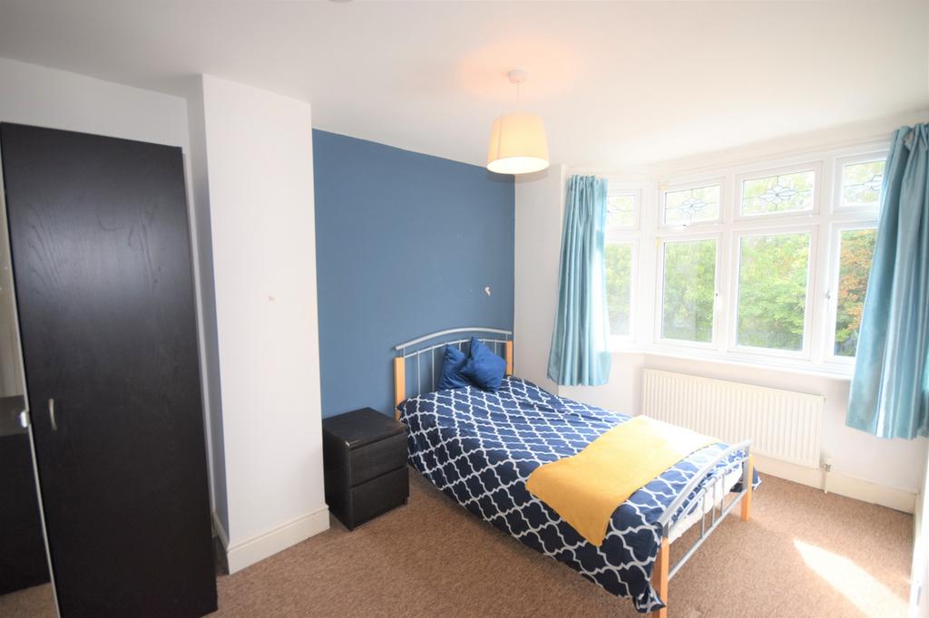 A bright and inviting double bedroom featuring ...