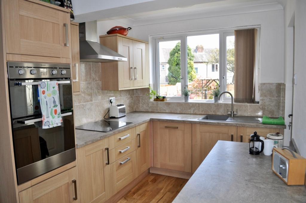 A bright and modern kitchen featuring ample cou...