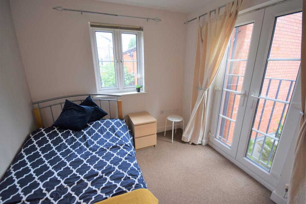 A bright and tidy double bedroom featuring larg...