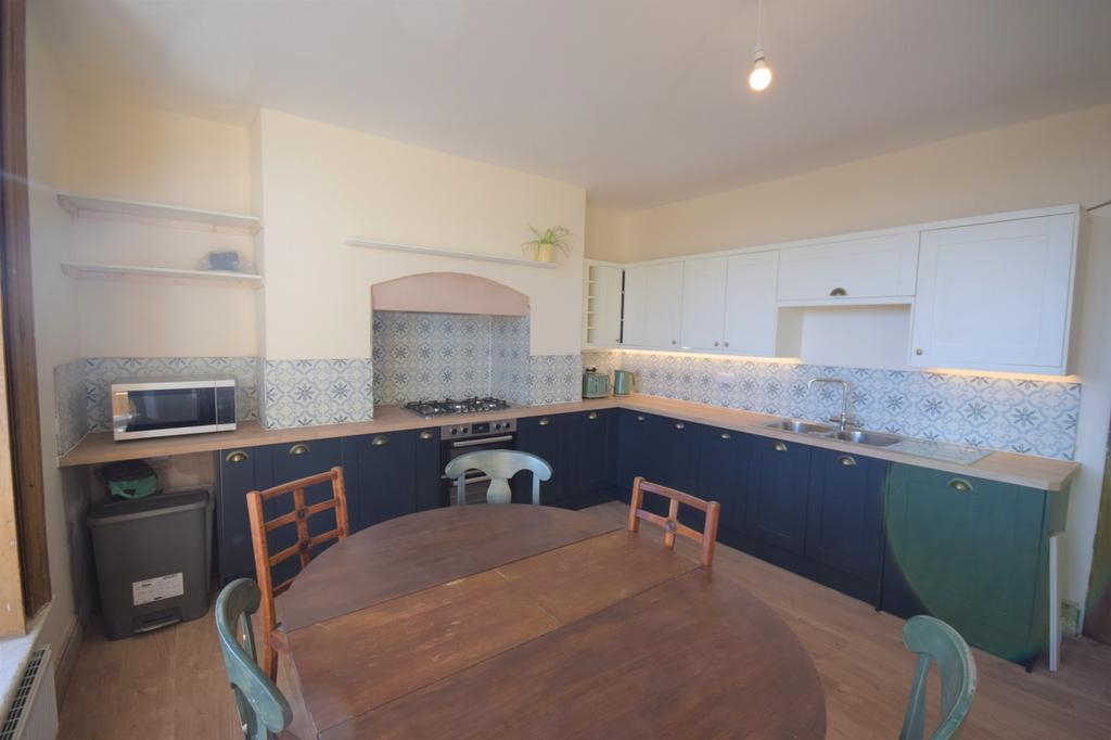 A bright and tidy kitchen with modern fixtures,...