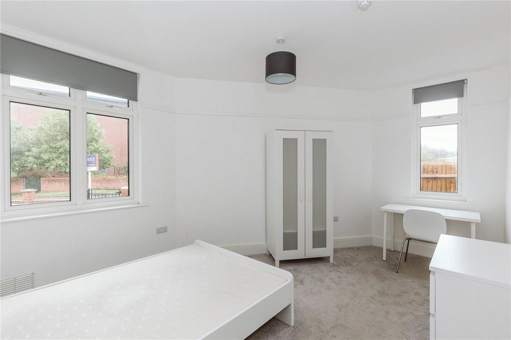 A bright and spacious double bedroom featuring ...