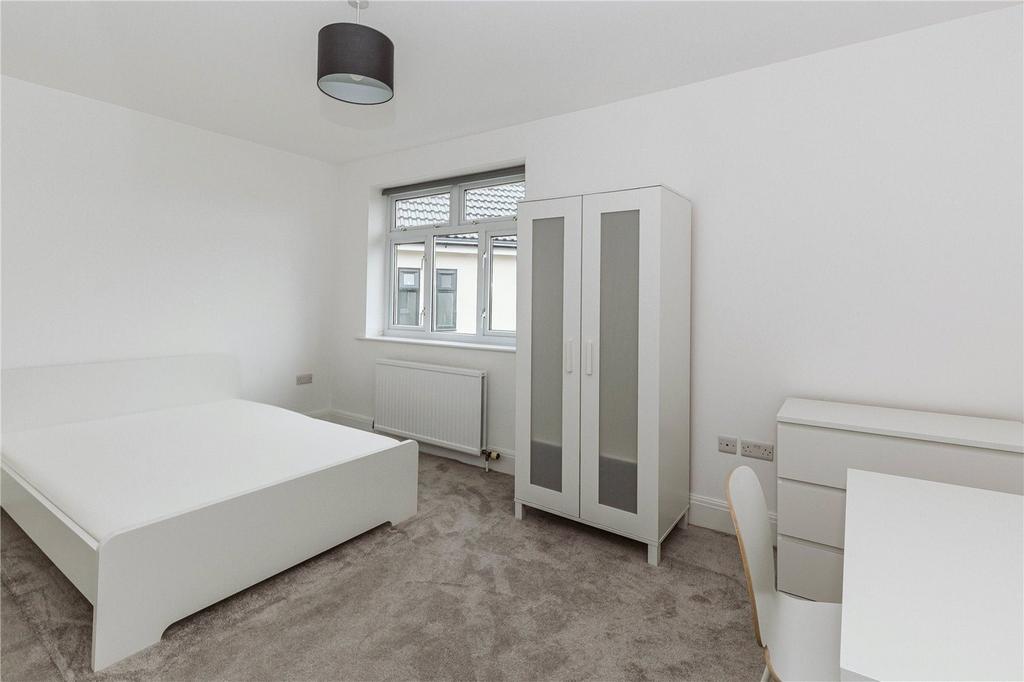 A spacious and bright double bedroom featuring ...