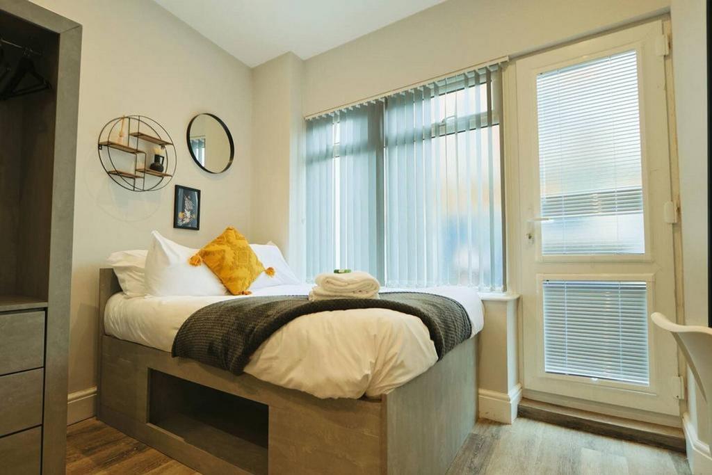 A bright and inviting double bedroom with moder...