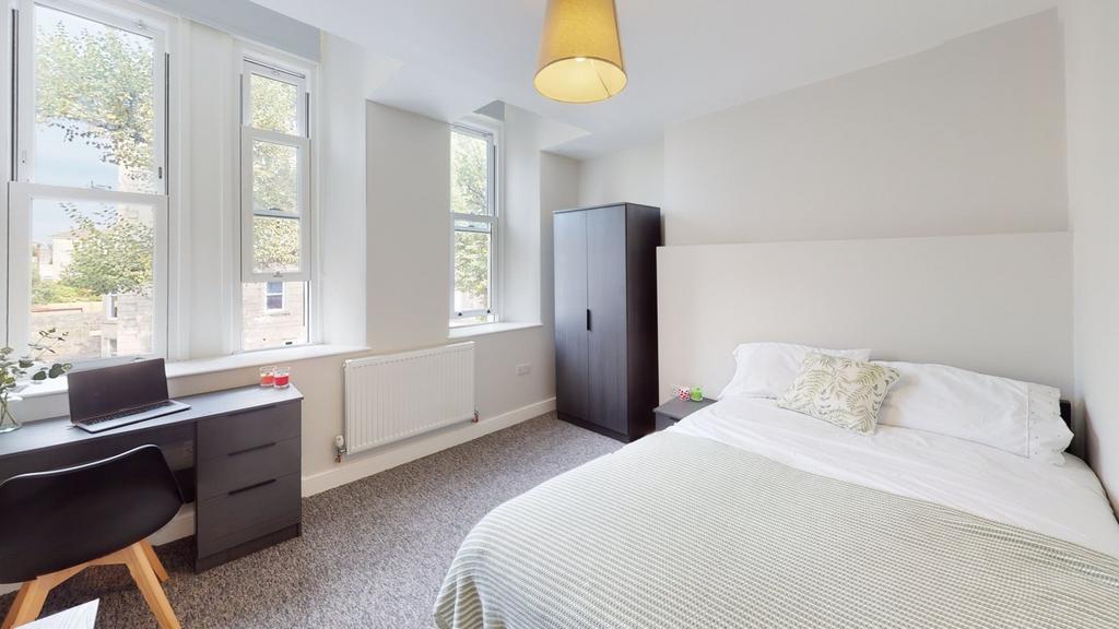 A bright and spacious double bedroom featuring ...