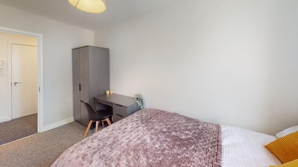 A spacious and inviting double bedroom featurin...